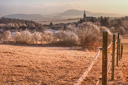 inline brown wooden post fence on brown field at daytime thumbnail