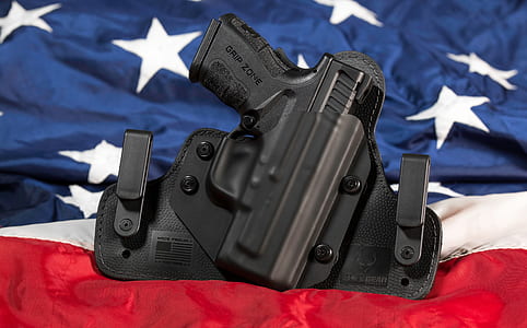 black semi-automatic pistol with holster thumbnail