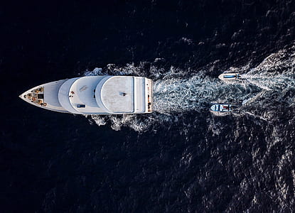birds eye photography of two boat following white yacht thumbnail