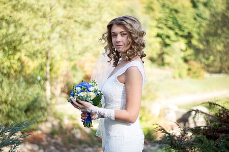 bridge wearing bridal gloves holding bouquet of flowers thumbnail