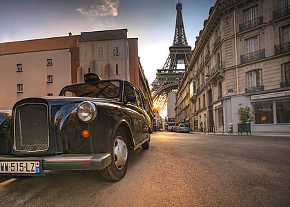 photo of black car on pavement with Eiffel Tower background thumbnail