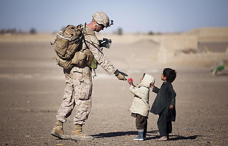 child giving a pink ball to a marine soldier thumbnail