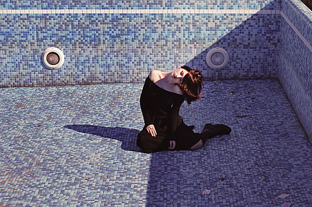 woman sitting on blue tiles thumbnail