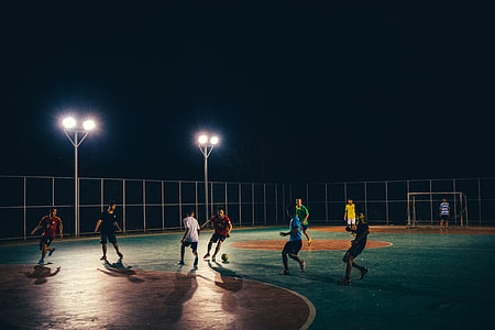 group of person playing basketball during nighttime thumbnail