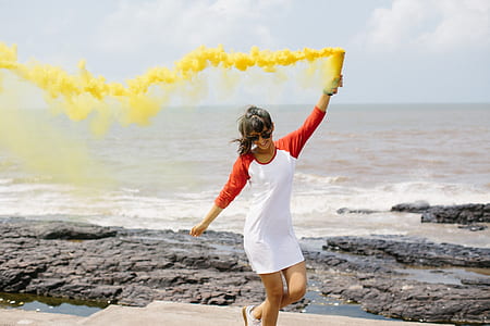 woman holding yellow smoke grenade thumbnail