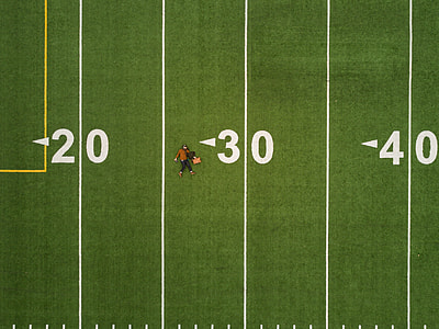 man laying on football 30 yard thumbnail