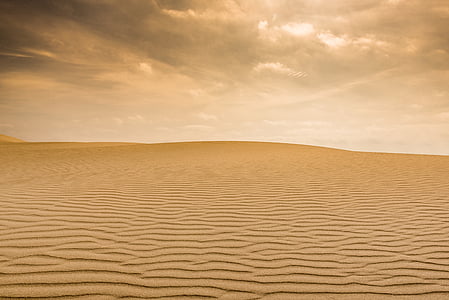 photo of brown sand under white clouds at noontime thumbnail