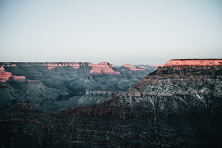 Sunrise over Canyon peaks with layered rock formations in the foreground thumbnail