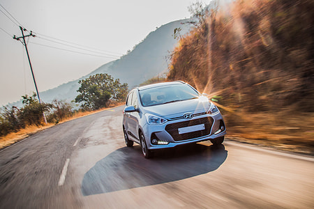time lapse photography of silver Hyundai i10 5-door hatchback on road thumbnail