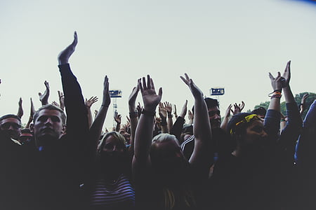 crowd of people raising arms thumbnail