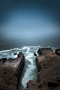 aerial photography of rocks near body of water thumbnail