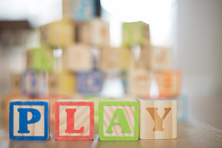 Depth of Field Photography of P, L, A, Y Wooden Letter Decors on Top of Beige Wooden Surface thumbnail