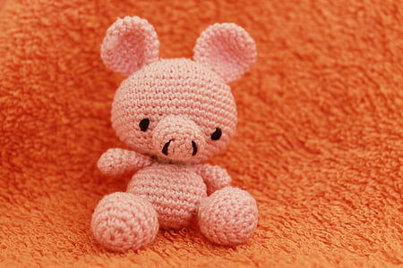 pink bear knitted plush toy on orange textile thumbnail