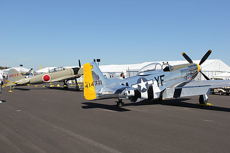 two gray biplane on gray concrete pavement thumbnail
