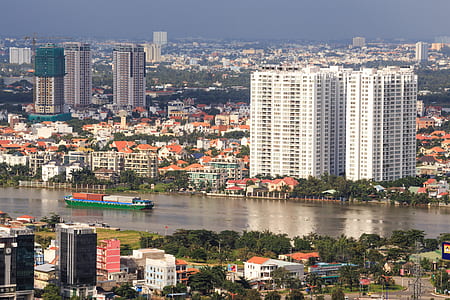 green boat beside city skyline thumbnail