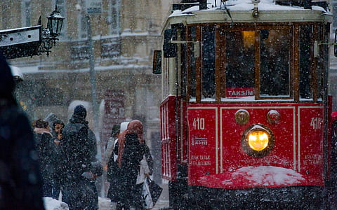 people near red tram during daytime thumbnail