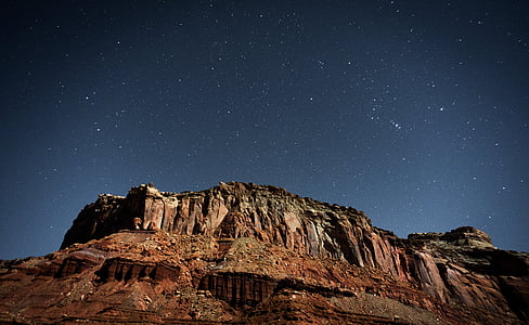 brown mountain under starry sky thumbnail