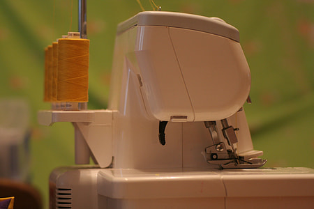selective focus photo of white electric sewing machine thumbnail