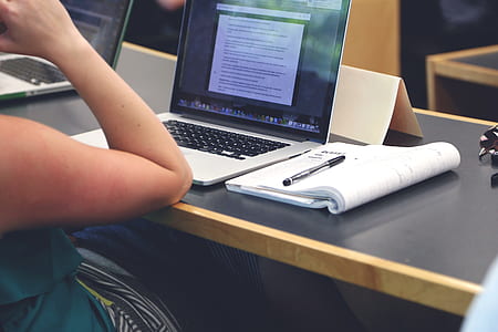 person sitting in front of turned on MacBook Pro thumbnail