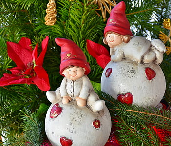 two Christmas elves ceramic baubles placed on Christmas tree thumbnail