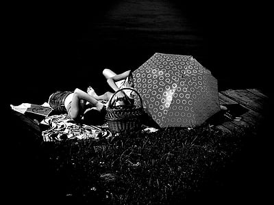 couple lying on ground with umbrella and basket thumbnail