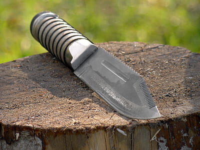 gray metal combat knife on trunk thumbnail