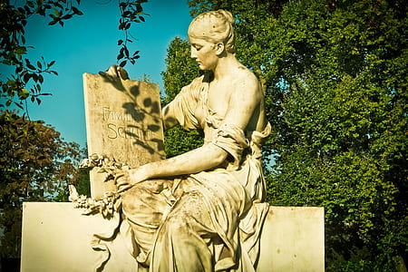 ceramic human statue near trees thumbnail