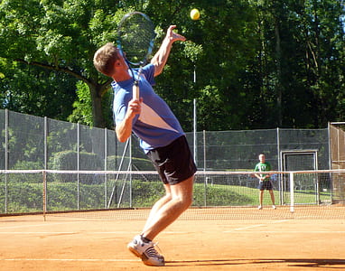 man serving on tennis game during daytime thumbnail