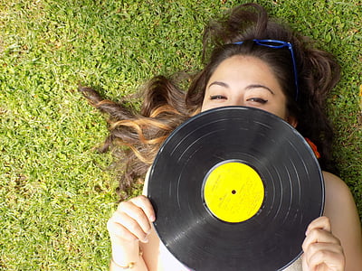 woman holding vinyl disc thumbnail