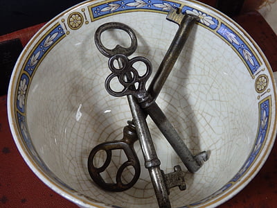 three gray skeleton keys on white bowl thumbnail