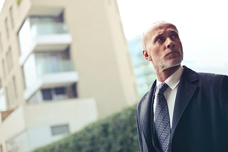 Old Aged Man Standing Outside a Building in formal clothing thumbnail