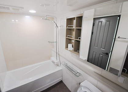 white ceramic bathtub and wooden wall mount shelf thumbnail