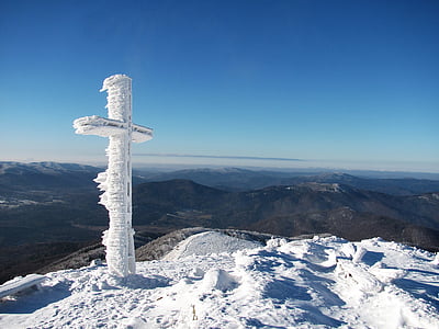 snow covered cross on top of mountain during daytime thumbnail