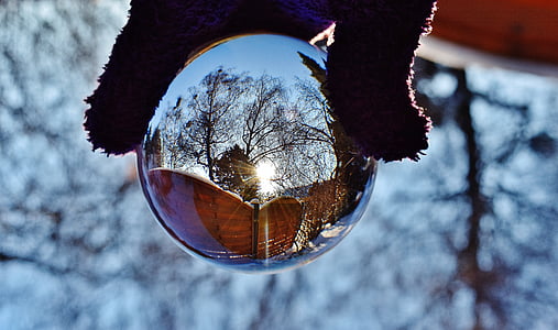 close-up photo of person holding glass ball thumbnail