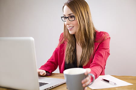 woman wearing red blazer holding gray ceramic mug thumbnail