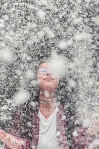 candid photography of woman catching snow thumbnail