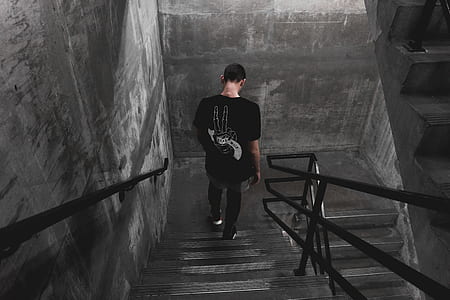 man looking down standing on staircase thumbnail