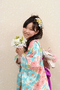 girl wearing kimono holding flowers thumbnail