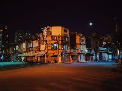 people walking on street beside house during nighttime thumbnail