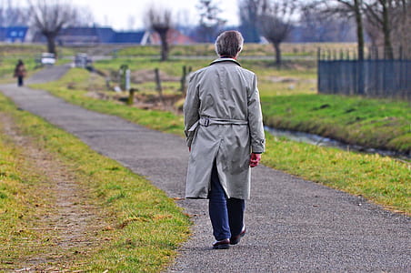 man walking near river during daytime thumbnail