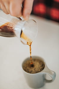 person pouring coffee in mug thumbnail