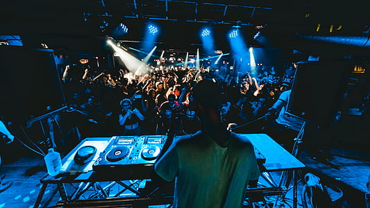 man standing on stage in front of people and turntable thumbnail