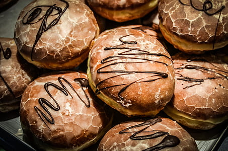 bunch of chocolate donut topped with chocolate syrup thumbnail