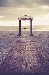 brown wooden dock near ocean thumbnail