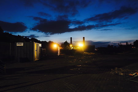 lights turned on near buildings under blue and black sky thumbnail
