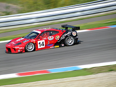 red and black sports coupe passing by at daytime thumbnail
