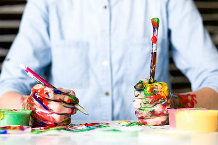 person's hands covered in paint thumbnail