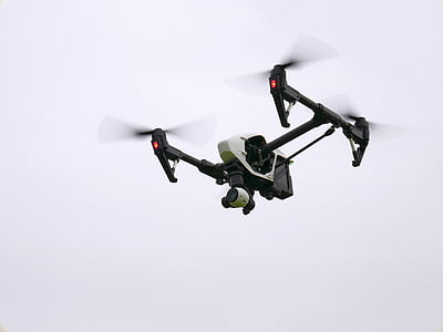 white and black quadcopter drone in flight thumbnail