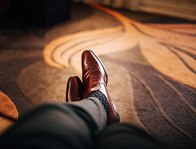 person wearing brown leather loafers thumbnail