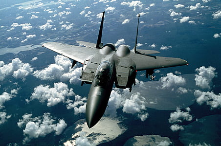 gray jet fighter above clouds during daytime thumbnail